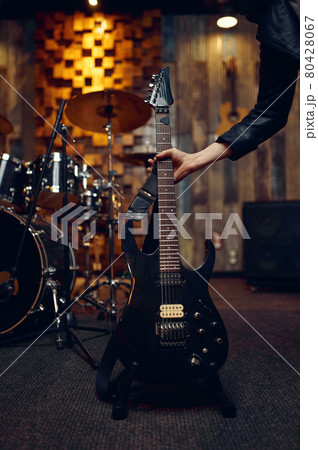 Musician takes electric guitar, music performing Musician takes electric guitar, music performing 80428067