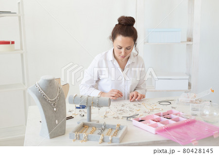 Professional accessories designer making handmade jewelry in studio workshop. Fashion, creativity and handmade concept. 80428145