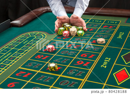 Picture of a green table and betting with chips. Picture of a green table and betting with chips. 80428188