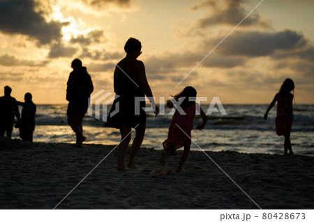 Family vacation sunset happy together at the beach Family vacation sunset happy together at the beach 80428673