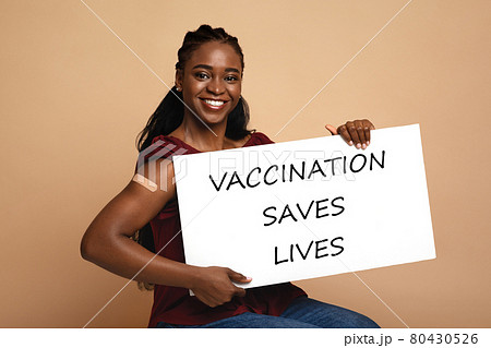 Pretty black woman with Vaccination Saves Lives placard 80430526
