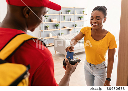 Black Female Paying With Credit Card For Delivery At Home Black Female Paying With Credit Card For Delivery At Home 80430638