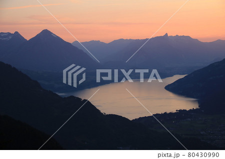Red evening sky over Lake Thun and mountain ranges in Switzerland. Red evening sky over Lake Thun and mountain ranges in Switzerland. 80430990