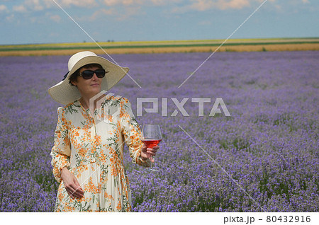 Woman with Rose Wine In Lavender Field 80432916