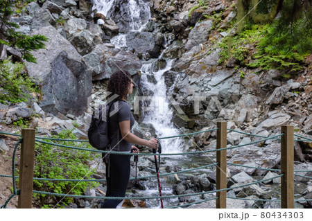 Adventurous White Caucasin Adult Woman Hiking on a trail in Canadian Nature 80434303
