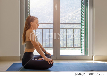 Young woman practicing deep yoga nauli breathing Young woman practicing deep yoga nauli breathing 80435727