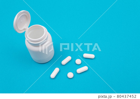 Pharmaceutical Industry and Medicinal Products - White Pills on Blue Table Pharmaceutical Industry and Medicinal Products - White Pills on Blue Table 80437452