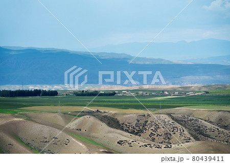 Grassland and mountains in a cloudy day. Grassland and mountains in a cloudy day. 80439411