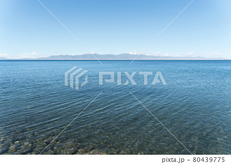 Calm surface of the lake with a sunny day. Shot in Sayram Lake in Xinjiang, China. Calm surface of the lake with a sunny day. Shot in Sayram Lake in Xinjiang, China. 80439775