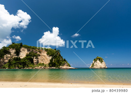 Idyllic tropical beach, emerald green sea, coastal rocks, blue sky. Iriomote Island. Idyllic tropical beach, emerald green sea, coastal rocks, blue sky. Iriomote Island. 80439980
