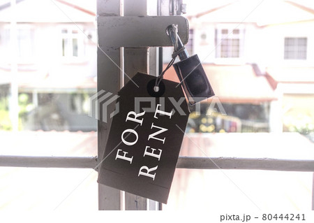 Text on tag and pad lock hanging on the window grill with blurred background of houses Text on tag and pad lock hanging on the window grill with blurred background of houses 80444241