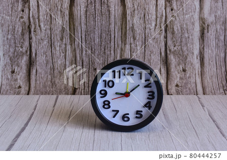 Black alarm clock on wooden table, space for text Black alarm clock on wooden table, space for text 80444257