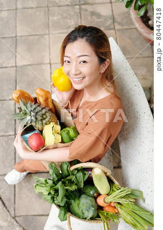 Young Woman with Bag of Groceries Young Woman with Bag of Groceries 80447418