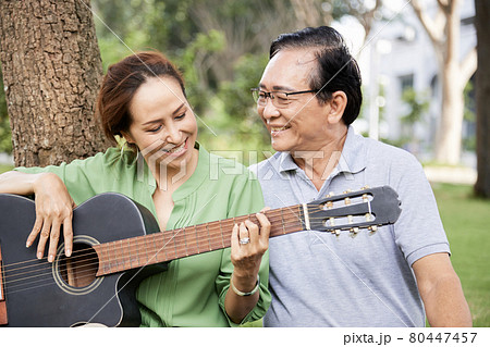 Senior Woman Playing Guitar for Husband Senior Woman Playing Guitar for Husband 80447457