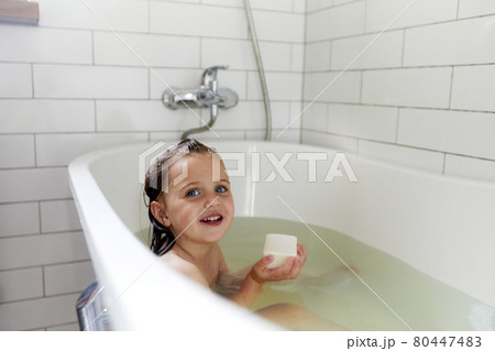 Smiling girl having bath in bathtube bathroom Smiling girl having bath in bathtube bathroom 80447483