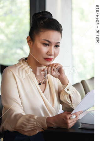 Pensive Busiesswoman with Reportの写真素材 [80447819] - PIXTA