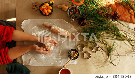 Woman making homemade gingerbread cookies for Christmas, holiday preparation, top view. Woman making homemade gingerbread cookies for Christmas, holiday preparation, top view. 80448048