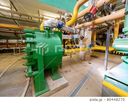 Green pressure tank connected to the piping system. 80448270