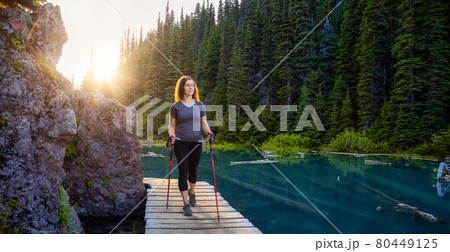 Adventurous White Caucasin Adult Woman Hiking on a trail in Canadian Nature Adventurous White Caucasin Adult Woman Hiking on a trail in Canadian Nature 80449125