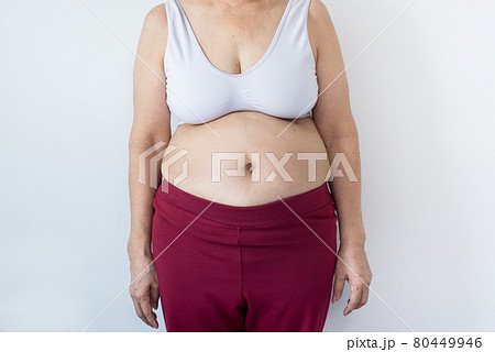 Overweight senior woman pinching her fat body,Cellulite around her belly button,Bloated belly,Healthy lifestyle concept 80449946