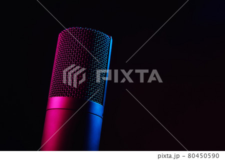 Studio microphone on dark background with neon lights 80450590