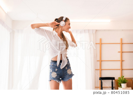 Young beautiful woman using headphone and listening to music and dance in bedroom,Relaxing time,Happy and smiling 80451085