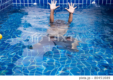 Blurred of hands man drowning in swimming pool 80451689