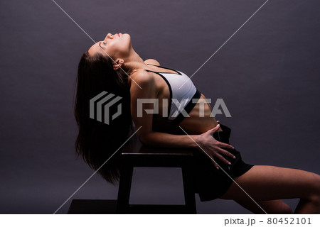Modern style dancer posing on studio background 80452101