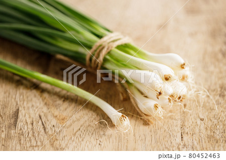 fresh green onions on wooden background fresh green onions on wooden background 80452463