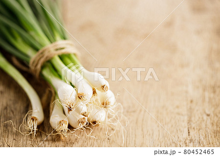 fresh green onions on wooden background fresh green onions on wooden background 80452465