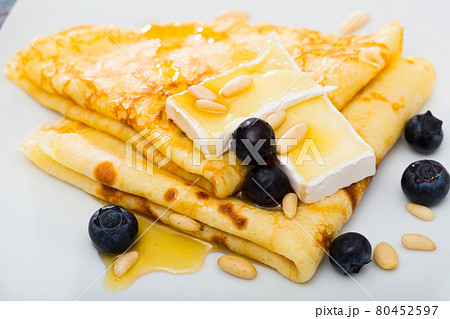 Pancakes with cheese brie and honey Pancakes with cheese brie and honey 80452597