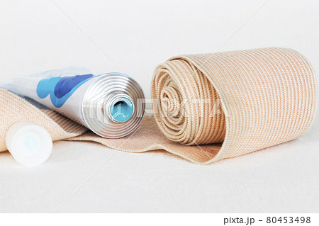 topical medication with roll bandage for first aid accident arrangement flat lay  80453498