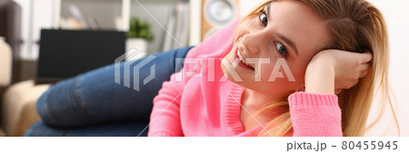 young pretty blond womansit on sofa hold smartphone in hands 80455945