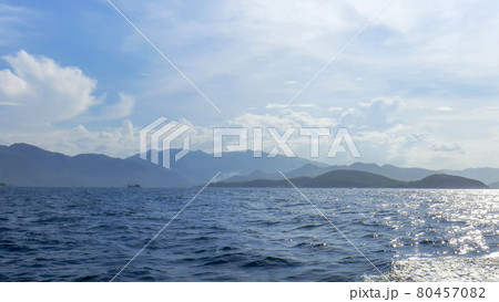 coastline of Vinperl Island, South China Sea, hills, sunlight, a small ship in the background 80457082