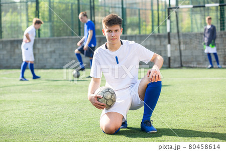 Portrait of football player holding football Portrait of football player holding football 80458614