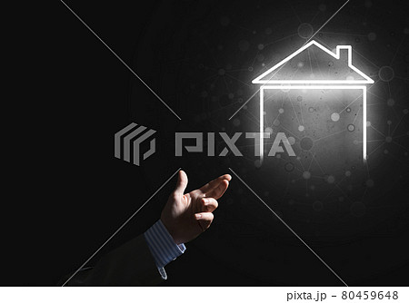 Conceptual image with hand pointing at house or main page icon on dark background 80459648