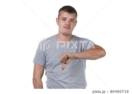 Photo of young man with bristle showing dislike gesture 80460719
