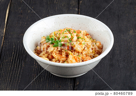 Asian seafood fried rice in a white bowl 80460789