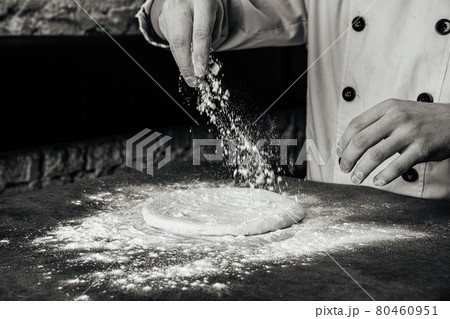 Hands making a pizza dough with flour Hands making a pizza dough with flour 80460951