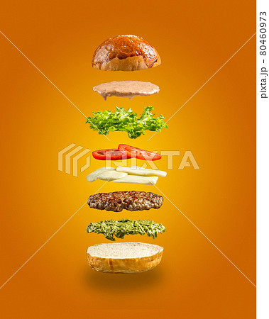 Floating burger ingredients on the yellow background 80460973