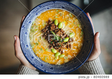 Hands holding a bowl of japanese ramen tantanmen 80460989