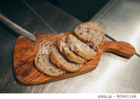Close-up image of bread slices served on a wooden board. Tasty delicious, airy, soft bakery . View from above Close-up image of bread slices served on a wooden board. Tasty delicious, airy, soft bakery . View from above 80461146
