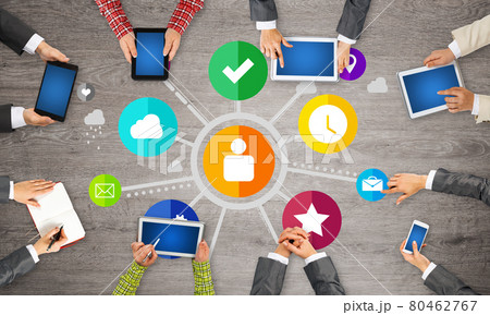 Top view of businesspeople sitting at table and using gadgets Top view of businesspeople sitting at table and using gadgets 80462767