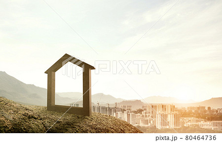 Conceptual image of concrete home sign on hill and natural lands 80464736