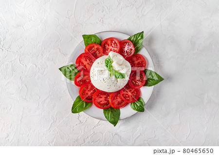 Traditional italian burrata cheese with basil and tomatoes 80465650