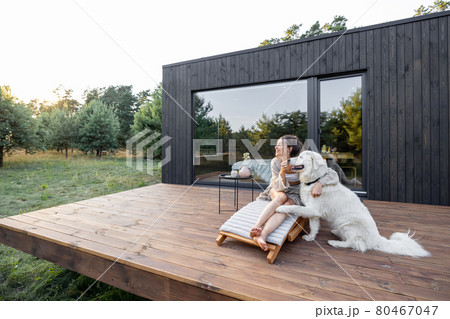 Woman enjoy nature at country house with pet Woman enjoy nature at country house with pet 80467047