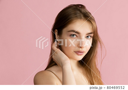 Close-up beautiful adorable young girl posing isolated over pink studio background. Natural beauty, spa, cosmetics and aesthetic cosmetology concept. 80469552