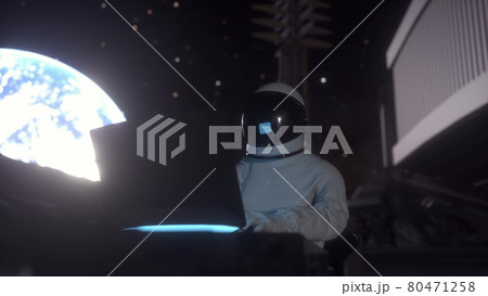 Astronaut works on his science laptop in a space colony on the moon. 3d rendering Astronaut works on his science laptop in a space colony on the moon. 3d rendering 80471258