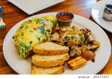 Close up shot of a plate of Omelette with bread and potato Close up shot of a plate of Omelette with bread and potato 80473957
