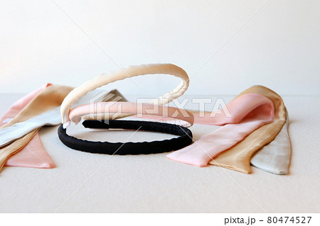 yellow and pink silk ribbons and Scrunchy isolated on white. Flat lay Hairdressing tools and accessoriesas Color Hair Scrunchies, Orbital Hair ring or hair hoop 80474527